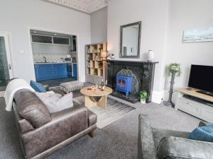 a living room with a couch and a fire place at Grand View in North Shields