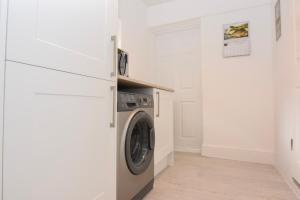 a laundry room with a washer and dryer at East View, a stunning home from home in St Helens, sleeps 6. in Saint Helens