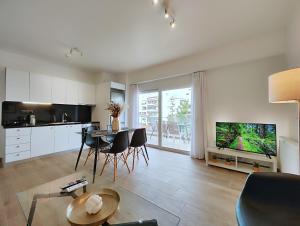 a kitchen and living room with a table and chairs at Marathonomachon Apartments by Verde Apartments in Athens