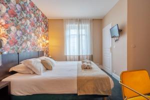 Postel nebo postele na pokoji v ubytování Ama Hôtel