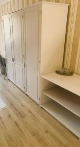 a room with white cabinets and wooden floors at Hotel SEVERKA in Zákopčie +73 photos