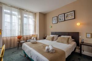 Postel nebo postele na pokoji v ubytování Ama Hôtel