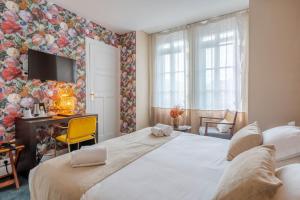 Postel nebo postele na pokoji v ubytování Ama Hôtel