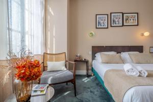 Postel nebo postele na pokoji v ubytování Ama Hôtel