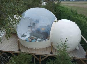 an orb and a ball on a wooden deck at Ecolieu B & Bubble Drincham by BubbleTree BBT SARL in Drincham