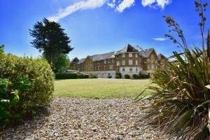 a large house with a large grass yard at 16 Solent Landing in Bembridge