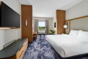 a hotel room with a large bed and a television at Fairfield Inn & Suites Homestead Florida City in Florida City