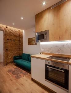 a kitchen with a stove and a couch in a room at Luxury flat Salamanca V in Madrid