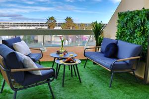 a patio with two chairs and a table on a balcony at 'Cap Confession' - Naturiste - Sea View - Beach - Parking -Air Conditionaire in Cap d'Agde