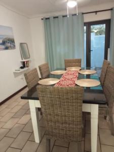 a dining room with a table and chairs at Windsor Place 6 in Uvongo Beach