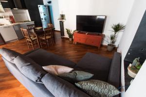 a living room with a couch and a kitchen at Orpheus Apartment in Turin