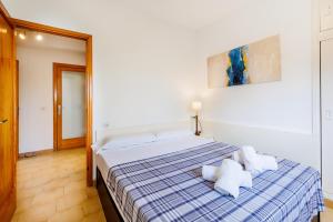a bedroom with a bed with two pillows on it at Les Ancores in Alcudia