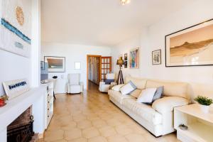 a living room with a white couch and chairs at Les Ancores in Alcudia