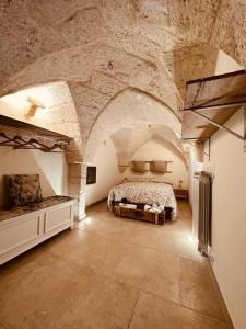 a large bedroom with a bed in a stone building at Casa in stile in Pezze di Greco