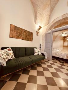 a living room with a green couch on a checkered floor at Casa in stile in Pezze di Greco +41 photos