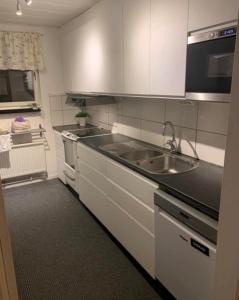 a kitchen with a sink and a stove at Own private room in a big house! in Luleå