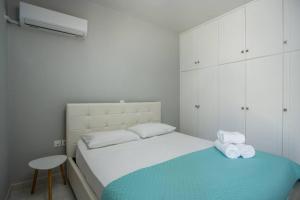 a bedroom with a bed with two towels on it at Pelagias apartments in Rhodes Town