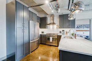 a kitchen with gray cabinets and stainless steel appliances at Sable 75 - Two Bedroom in Minneapolis