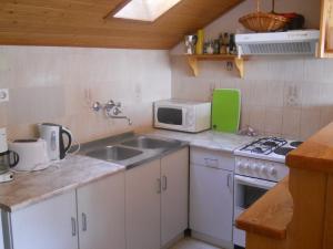 a small kitchen with a sink and a microwave at Apartments Ada Novak in Hvar +32 photos