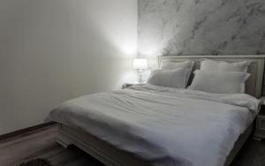 Postel nebo postele na pokoji v ubytování CooZee Apartment