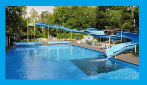 a water slide in a swimming pool at Luxe Chalet Leeuwenhart - recreation only in Hoenderloo