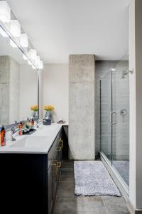 a bathroom with two sinks and a shower at Sable 51 Luxury Two Story Loft in Minneapolis