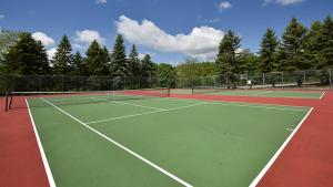 a tennis court with two tennis courts at Seven Springs 1 Bedroom Premium Condo, Ski In Ski Out condo in Champion