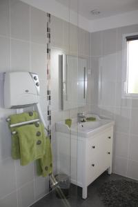 a white bathroom with a sink and a mirror at Le Clos Marie in Sausseuzemare-en-Caux +32 photos