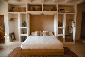 a bedroom with a large white bed and shelves at The JTH Tucson in Tucson