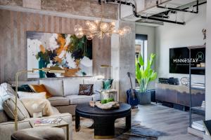 a living room with a couch and a table at Sable 51 Luxury Two Story Loft in Minneapolis