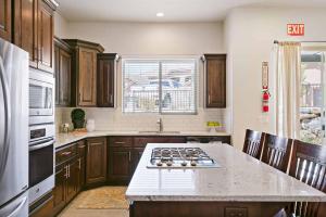 a kitchen with wooden cabinets and a stove top oven at Pebble Beach Oasis home in Washington