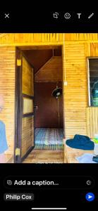 an open door to a room in a wooden house at Elena Guest House & Resort in Medellin