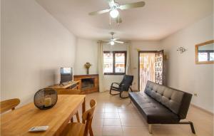 a living room with a couch and a table at Pet Friendly Home In Santa Pola With Kitchenette in Santa Pola