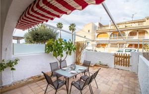 a patio with a table and chairs and an umbrella at Pet Friendly Home In Santa Pola With Kitchenette in Santa Pola