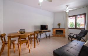 a living room with a table and chairs and a fireplace at Pet Friendly Home In Santa Pola With Kitchenette in Santa Pola