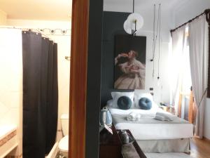 a bedroom with a bed with a painting on the wall at Les Monges Palace Boutique in Alicante