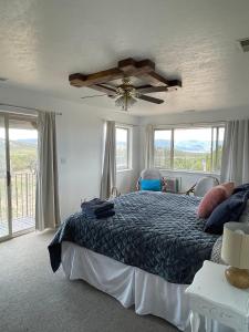 a bedroom with a bed and a ceiling fan at The Harmony Studio at Wind Walker Homestead in Spring City