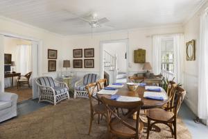 a dining room with a table and chairs at Tamarind home in Governorʼs Harbour