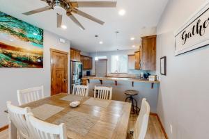 a kitchen and dining room with a wooden table and chairs at Sunset Beach House in Coos Bay