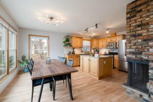 a kitchen with a wooden table and a fireplace at Linden Hills Retreat in Minneapolis