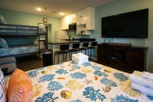 a living room with a table with a flowered table cloth at 530 Sunsuite in Fripp Island