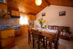a kitchen with a table and chairs in a room at Georgias Loft Acharavi Corfu in Acharavi +7 photos