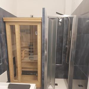 a bathroom with a shower and a glass door at Hotel Holiday- Alla Finestrella in Bologna