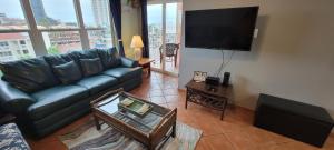 a living room with a couch and a flat screen tv at Gulfview II #604 in South Padre Island