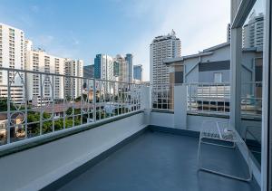 a balcony with a bench on top of a building at Boxpackers Pratunam in Bangkok