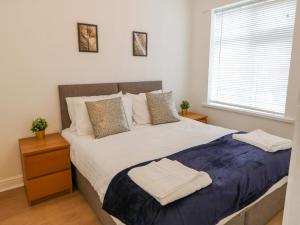 a bedroom with a large bed and a window at Hartlepool Heaven in Hartlepool