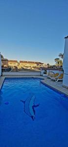 a swimming pool with a shark in the water at Apartamento en L´Ampolla in L'Ampolla