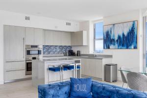 a living room with a blue couch in a kitchen at HYDE BEACH HOUSE - MILLIONAIRE 2 bd 2 ba APT, DIRECT OCEAN VIEW, 5 MIN WALK TO OCEAN in Hollywood