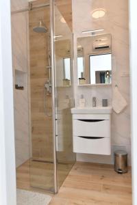 a bathroom with a shower and a sink at Apartman Leona in Lovran