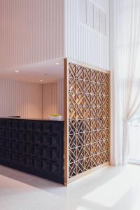 a room with a partition with a wall of wine bottles at Cadillac Hotel & Beach Club, Autograph Collection in Miami Beach